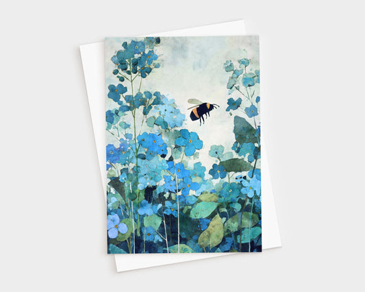 Watercolor-style greeting card featuring a bumblebee hovering among soft blue forget-me-not flowers with layered teal and green foliage. The card is shown with a white envelope, highlighting a calm, nature-inspired botanical design in cool blue tones.