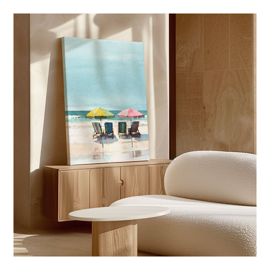 Interior view featuring a watercolor painting of a beach scene, displayed on a wooden cabinet beside a white textured sofa, illuminated by natural light.