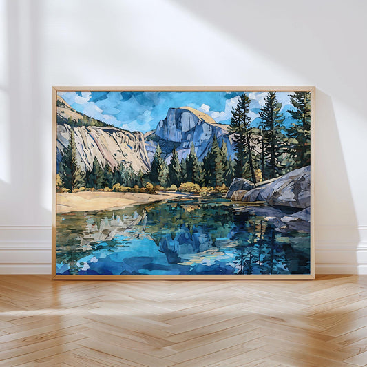 Framed art print of Yosemite’s Half Dome with pine trees and rocky cliffs reflected in a calm blue river, painted in a modern impressionist watercolor style. The artwork rests against a white wall on a light wood herringbone floor, lit by soft natural sunlight.