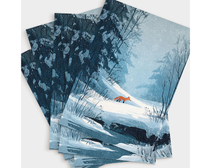Set of greeting cards featuring a winter illustration of a red fox walking through a snowy forest. The design shows soft blue and white tones with snow-covered trees, bare branches, and gentle snowfall, creating a serene, woodland atmosphere perfect for winter or holiday correspondence.
