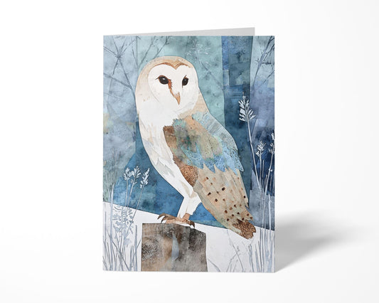 Folded greeting card featuring a watercolor-style barn owl perched on a wooden post in a snowy, blue-toned forest. The owl’s soft cream, brown, and muted blue feathers stand out against an abstract background of trees and winter foliage, creating a calm, nature-inspired design on a white backdrop.
