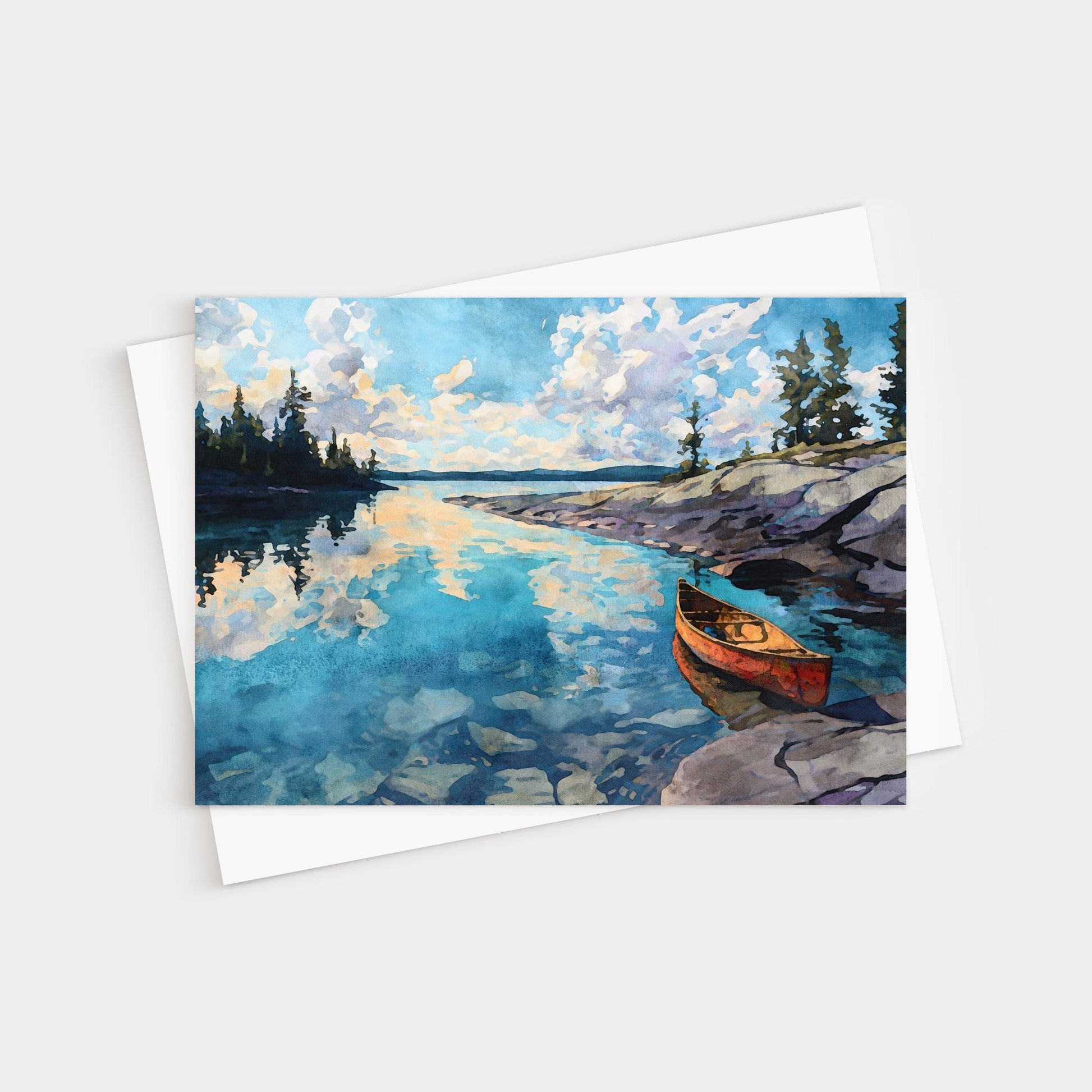 Watercolor greeting card featuring a serene lake scene with a red canoe resting on rocky shore. The calm blue water reflects fluffy clouds and pine trees along the horizon, capturing a peaceful wilderness atmosphere.