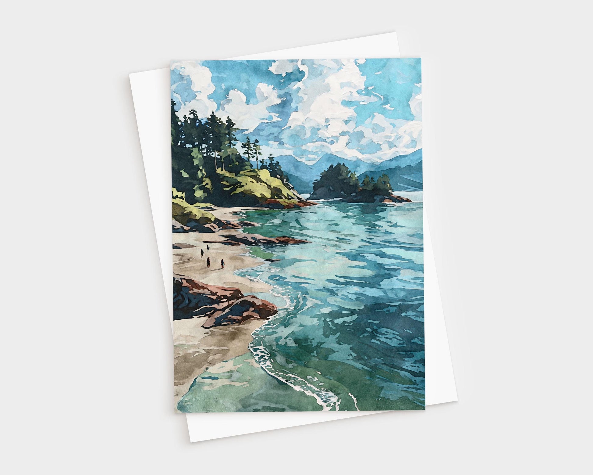 Watercolor-style greeting card featuring a scenic coastal landscape with turquoise waves, sandy beach, rocky shoreline, and pine-covered cliffs under a sky filled with fluffy white clouds. Card is paired with a white envelope.