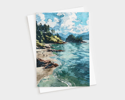 Watercolor-style greeting card featuring a scenic coastal landscape with turquoise waves, sandy beach, rocky shoreline, and pine-covered cliffs under a sky filled with fluffy white clouds. Card is paired with a white envelope.