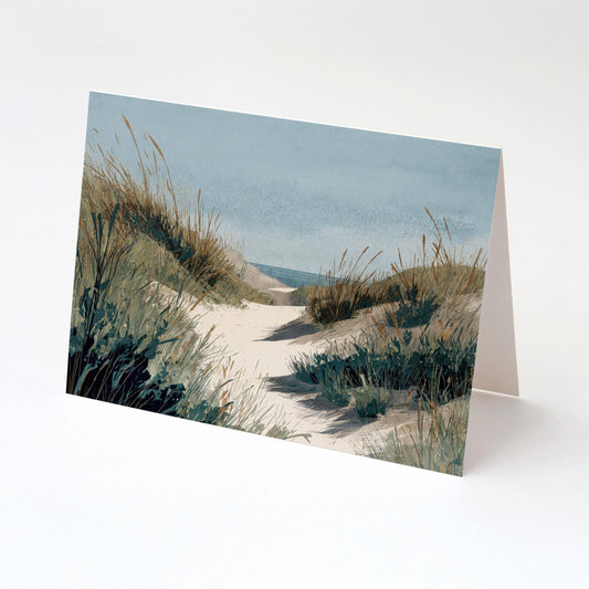 Folded greeting card featuring a watercolor illustration of a sandy beach path bordered by tall grasses and dunes, leading toward the ocean beneath a soft blue sky.