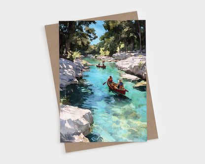 Watercolor-style greeting card showing two canoes gliding down a clear turquoise river, surrounded by rocky banks and tall green trees under a bright blue sky.