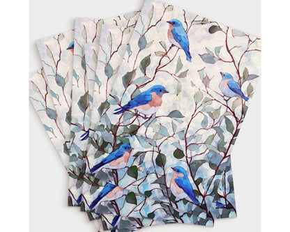 Set of greeting cards featuring a watercolor design of bluebirds with peachy chests perched on red-brown branches with soft green leaves against a pale, dappled background, fanned out in a neat stack.
