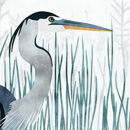 Close-up of a watercolor-style illustration of a great blue heron, focusing on its head, beak, and upper body. The bird has a golden eye, a long blue-and-orange beak, and sleek black feathers atop its head. Tall, blue-green reeds surround the heron, creating a tranquil marsh setting with soft, layered botanical silhouettes in the background.
