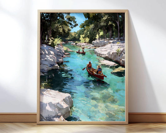 Framed watercolor-style painting of two people canoeing on a clear turquoise river surrounded by white stone cliffs and green trees, with another canoe in the distance under a bright blue sky.