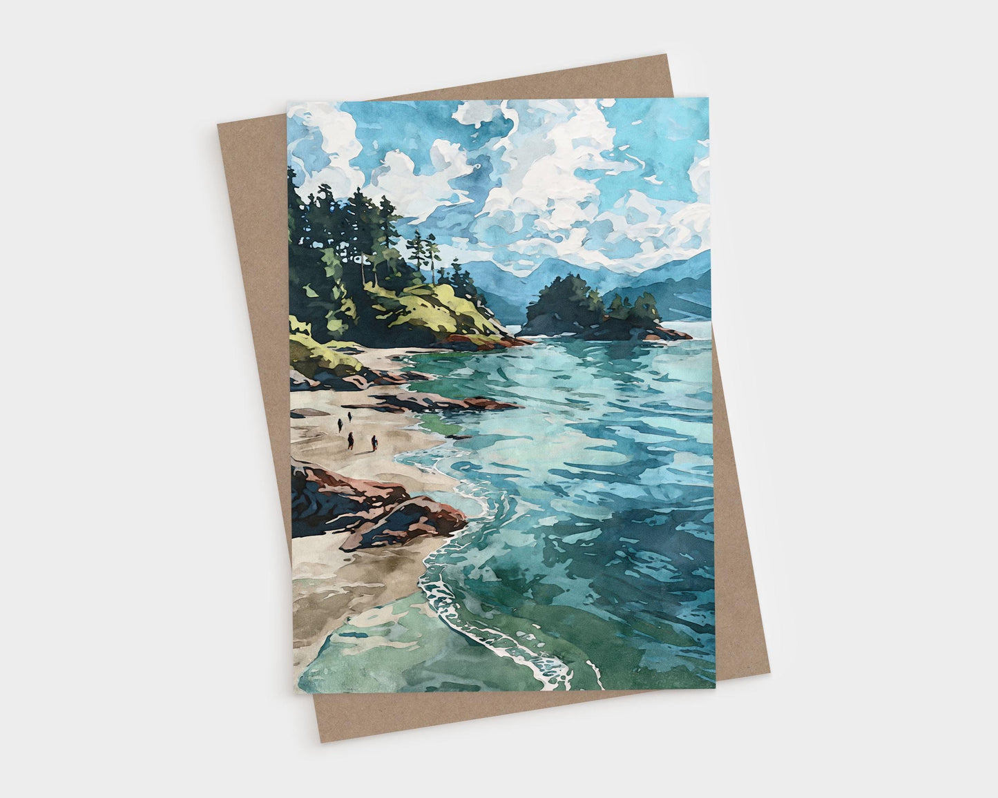 Watercolor-style greeting card featuring a scenic coastal landscape with turquoise waves, sandy beach, rocky shoreline, and pine-covered cliffs under a sky filled with fluffy white clouds. Card is paired with a brown kraft envelope.