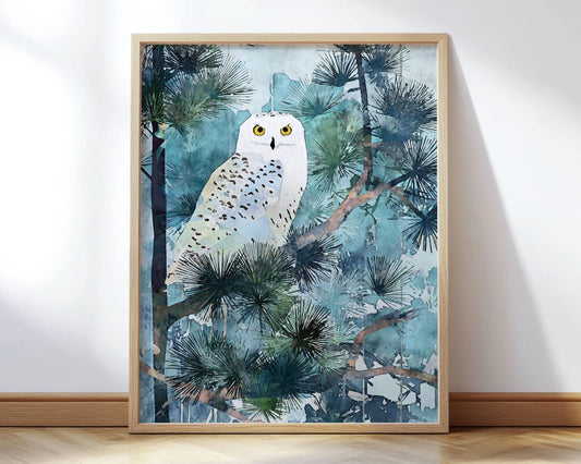 Watercolor-style art print of a snowy owl perched among pine branches, featuring soft blue, teal, and forest green tones with the owl’s bright yellow eyes as a focal point. The artwork is framed in light wood and displayed leaning against a white wall on a hardwood floor.