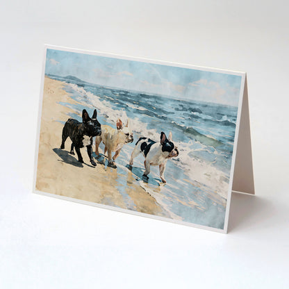 Three French Bulldogs beach note card displayed with a kraft envelope and blue tan coastal watercolor artwork.