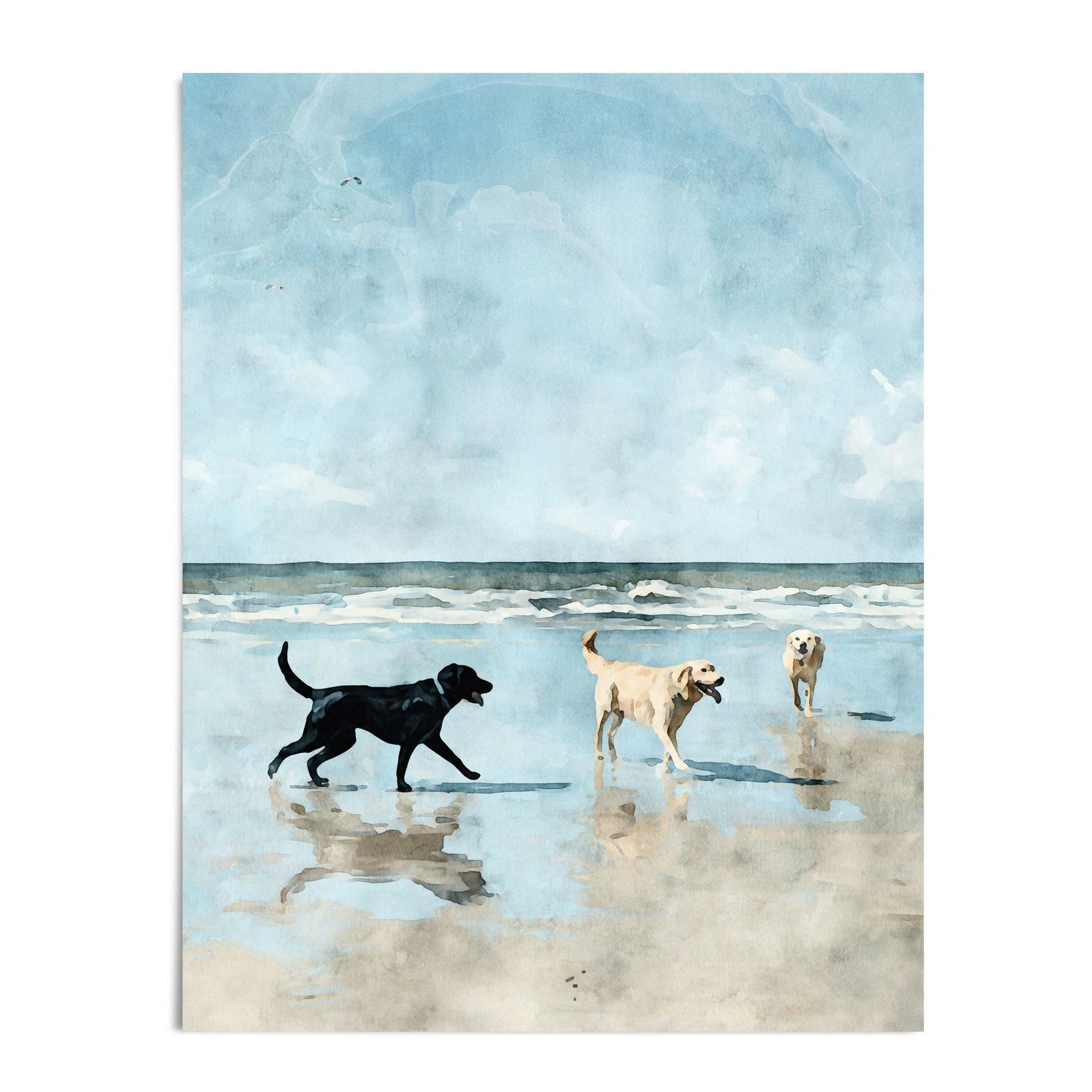 Watercolor-style print of three Labrador retrievers playing on a sandy beach, with ocean waves and a bright blue sky in the background. A black lab walks toward two yellow labs, one carrying a stick, all reflected in the wet sand.