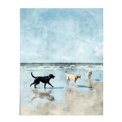 Watercolor-style print of three Labrador retrievers playing on a sandy beach, with ocean waves and a bright blue sky in the background. A black lab walks toward two yellow labs, one carrying a stick, all reflected in the wet sand.