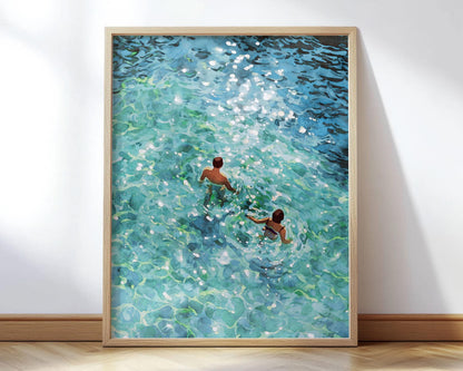 Framed painting of two swimmers seen from above, wading through clear turquoise water with sunlight sparkling on the surface, rendered in a vibrant, impressionistic style.