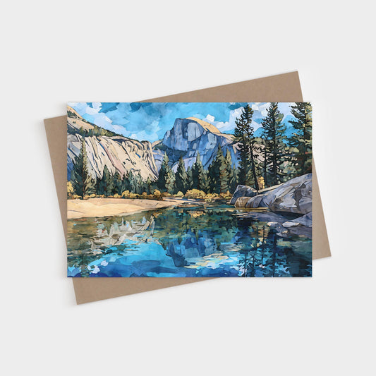 Watercolor-style greeting card featuring Yosemite’s Half Dome with tall pine trees and granite cliffs reflected in a clear blue river, set against a bright sky with soft clouds. A kraft envelope is shown behind the card.