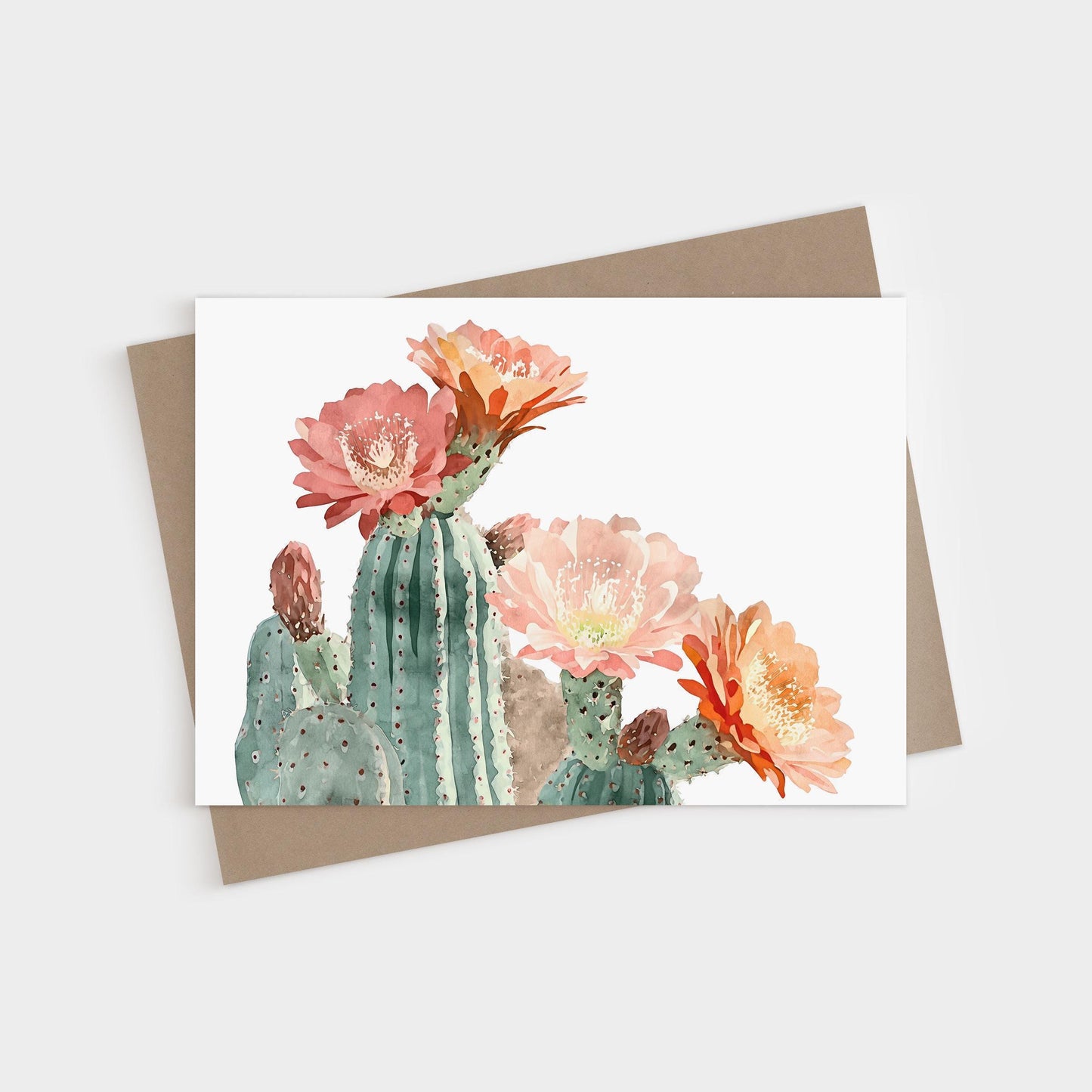 Watercolor greeting card featuring blooming cacti with large pink, peach, and orange flowers against a white background, paired with a brown kraft envelope.