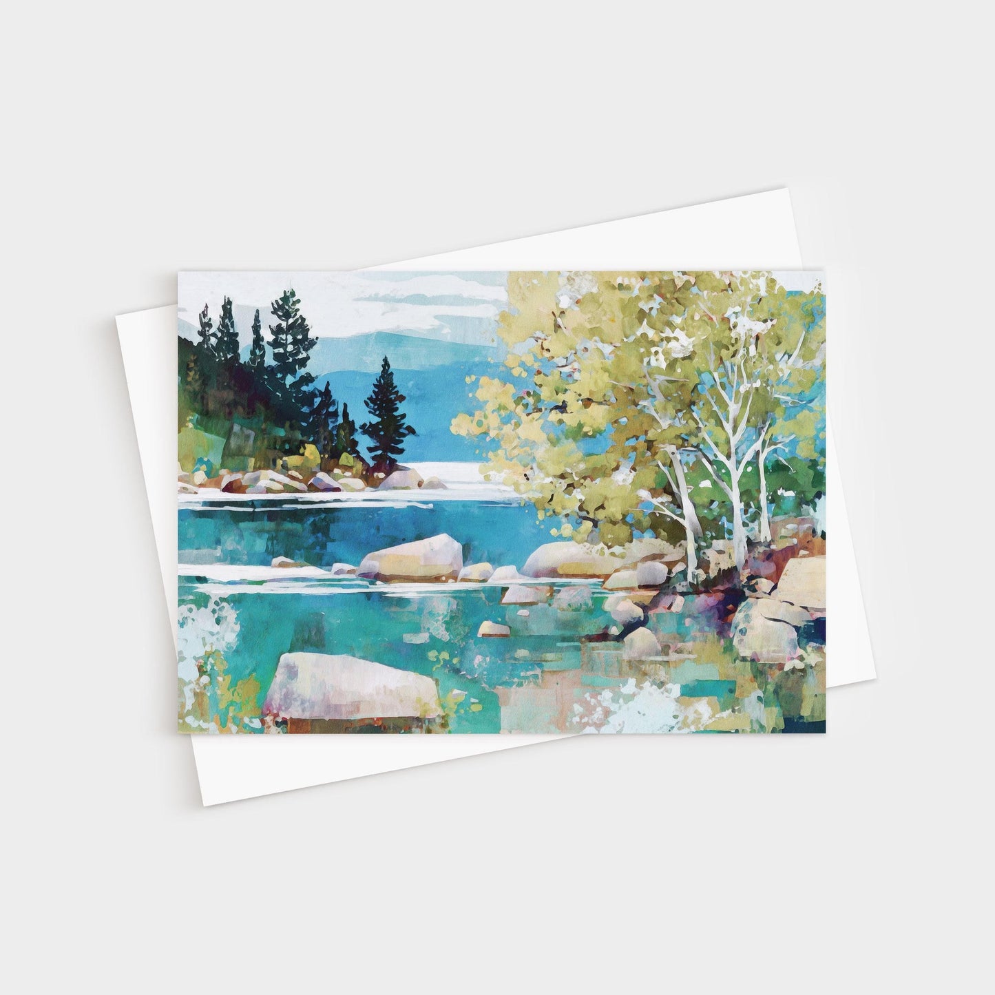 Greeting card featuring a modern impressionist landscape painting of a tranquil lake with turquoise water, smooth boulders, and shoreline trees. Birch trees with pale trunks and golden-green leaves stand in the foreground, while dark evergreens rise against distant mountains and a soft blue sky. Card is paired with a white envelope.