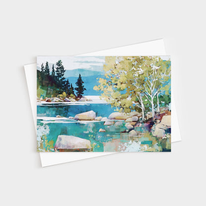 Greeting card featuring a modern impressionist landscape painting of a tranquil lake with turquoise water, smooth boulders, and shoreline trees. Birch trees with pale trunks and golden-green leaves stand in the foreground, while dark evergreens rise against distant mountains and a soft blue sky. Card is paired with a white envelope.