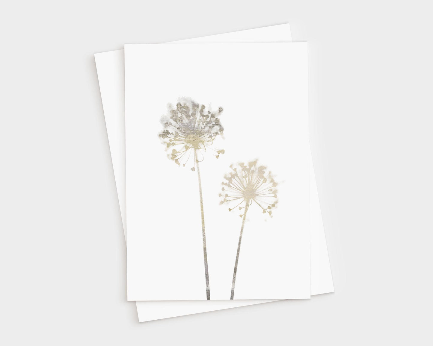 Greeting card featuring two delicate allium flowers in soft beige watercolor tones on white cardstock, paired with a white envelope, shown on a light background.