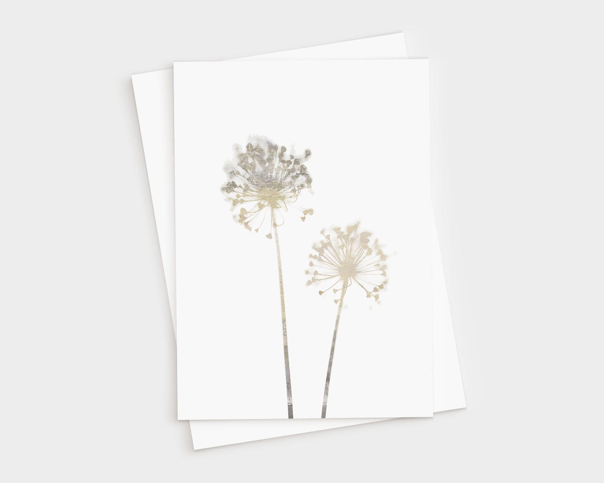 Greeting card featuring two delicate allium flowers in soft beige watercolor tones on white cardstock, paired with a white envelope, shown on a light background.