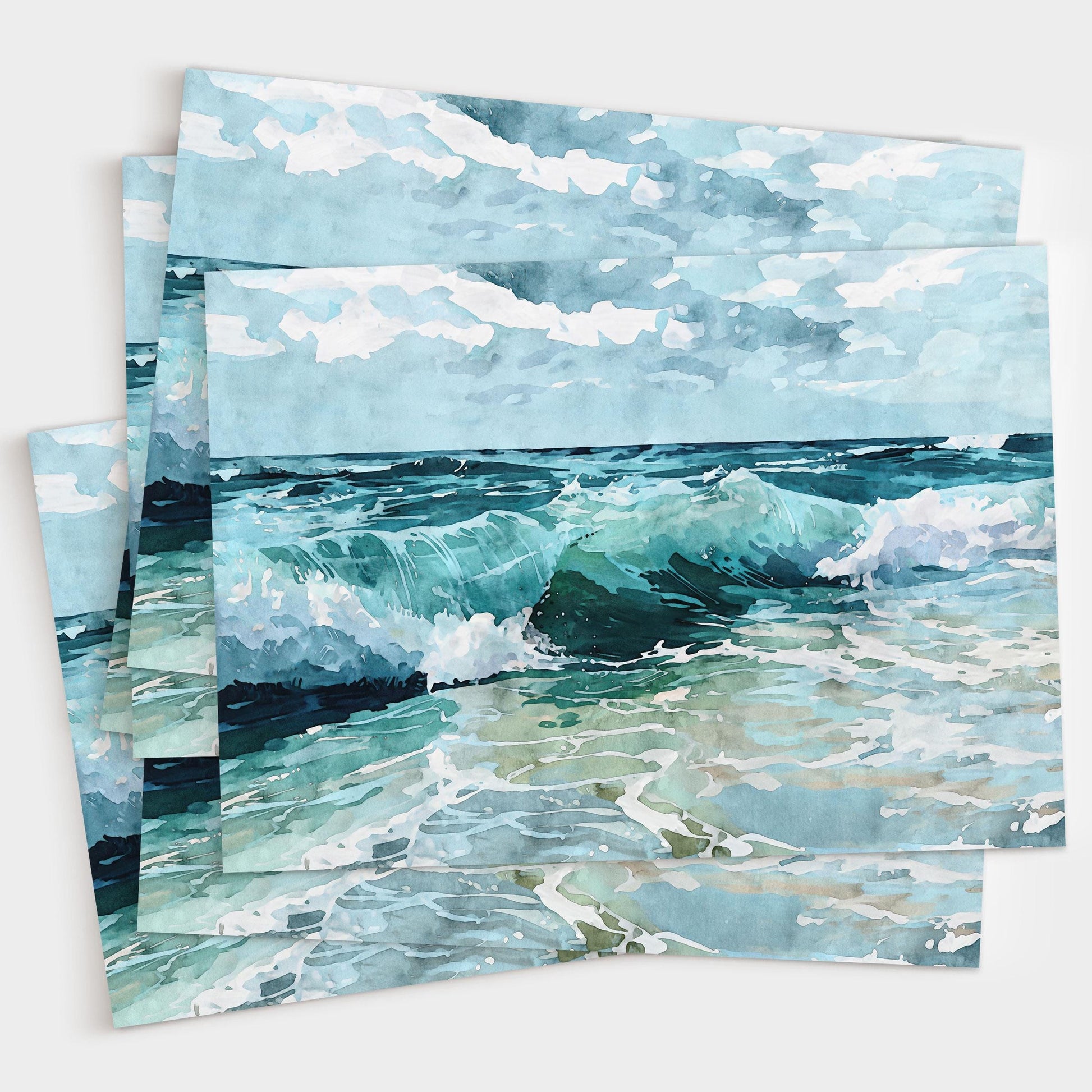 Set of watercolor greeting cards featuring turquoise ocean waves crashing under a cloudy sky, shown stacked in a small bundle against a white background.