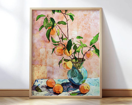Framed still life painting of peaches in a blue glass vase with leafy branches, set against a textured pink background. Three peaches rest on a blue-and-white cloth at the base, with rich green leaves and warm orange tones creating a vibrant, modern impressionist style.