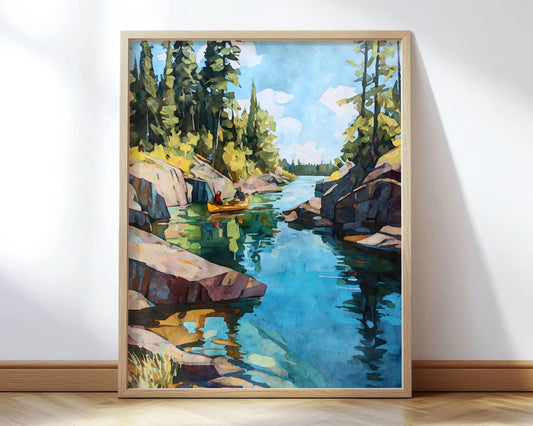 Framed painting of a serene lake scene with two people paddling a yellow canoe between rocky cliffs and tall pine trees, the clear blue water reflecting the sky and forest.