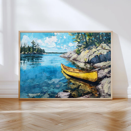 Watercolor-style art print of a bright yellow canoe resting beside rocky shoreline on a clear blue lake. Sunlit water reflects the sky and surrounding pine trees, creating a serene northern wilderness scene. The framed print leans against a white wall on a herringbone wood floor, with soft natural light highlighting the vibrant colors.