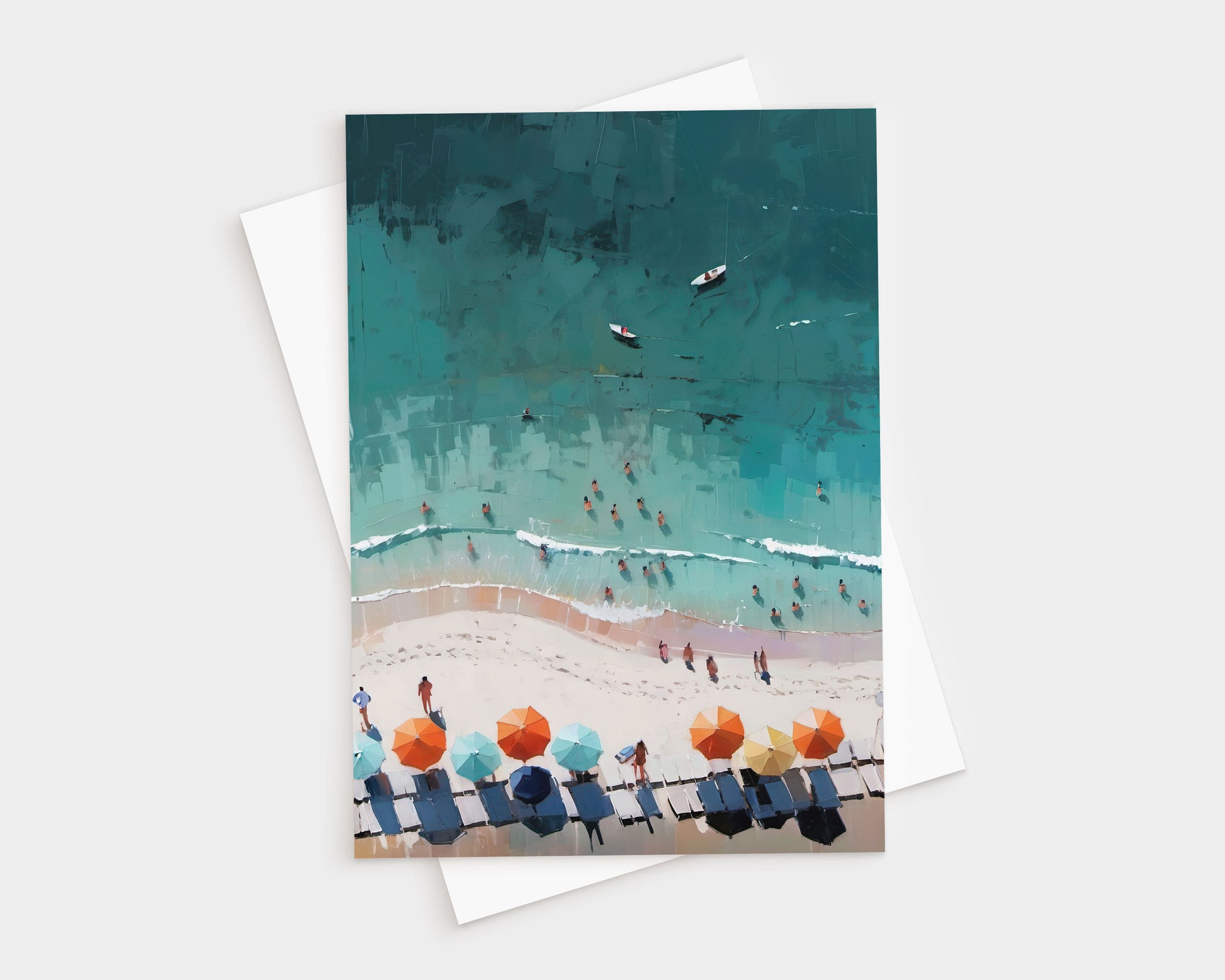 Greeting card featuring an aerial illustration of a beach scene with people in the water, colorful umbrellas, and lounge chairs on the sand; shown with a white envelope beneath.