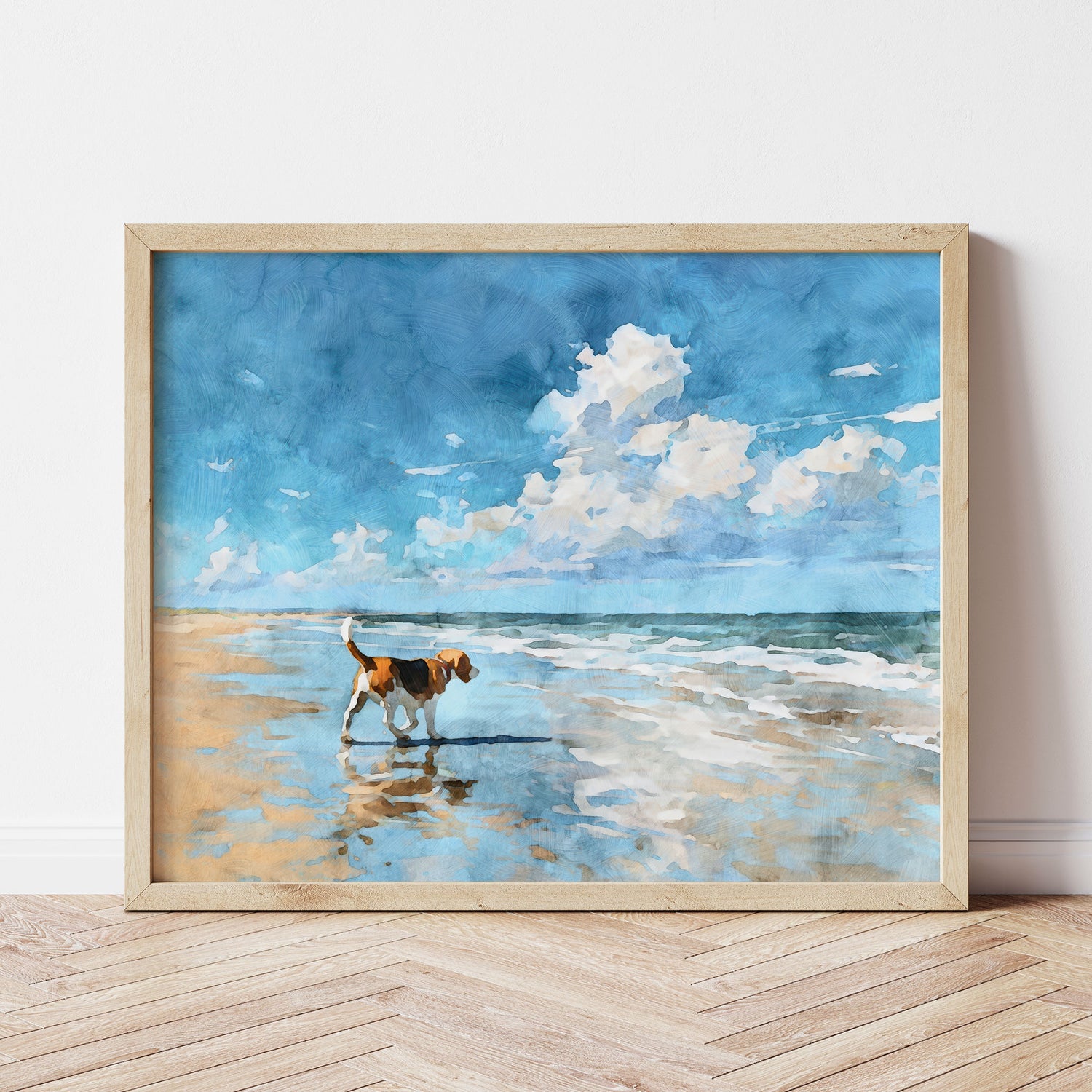 Watercolor-style illustration of a tricolor beagle walking along a sunlit beach shoreline, its reflection visible in wet sand. Gentle ocean waves roll in under a bright blue sky filled with soft white clouds, creating a calm, airy coastal scene in a horizontal composition with a light wood frame.