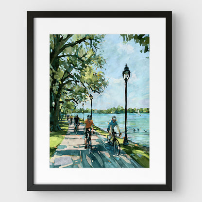 Matted Minneapolis Chain of Lakes bike path artwork in a black frame.