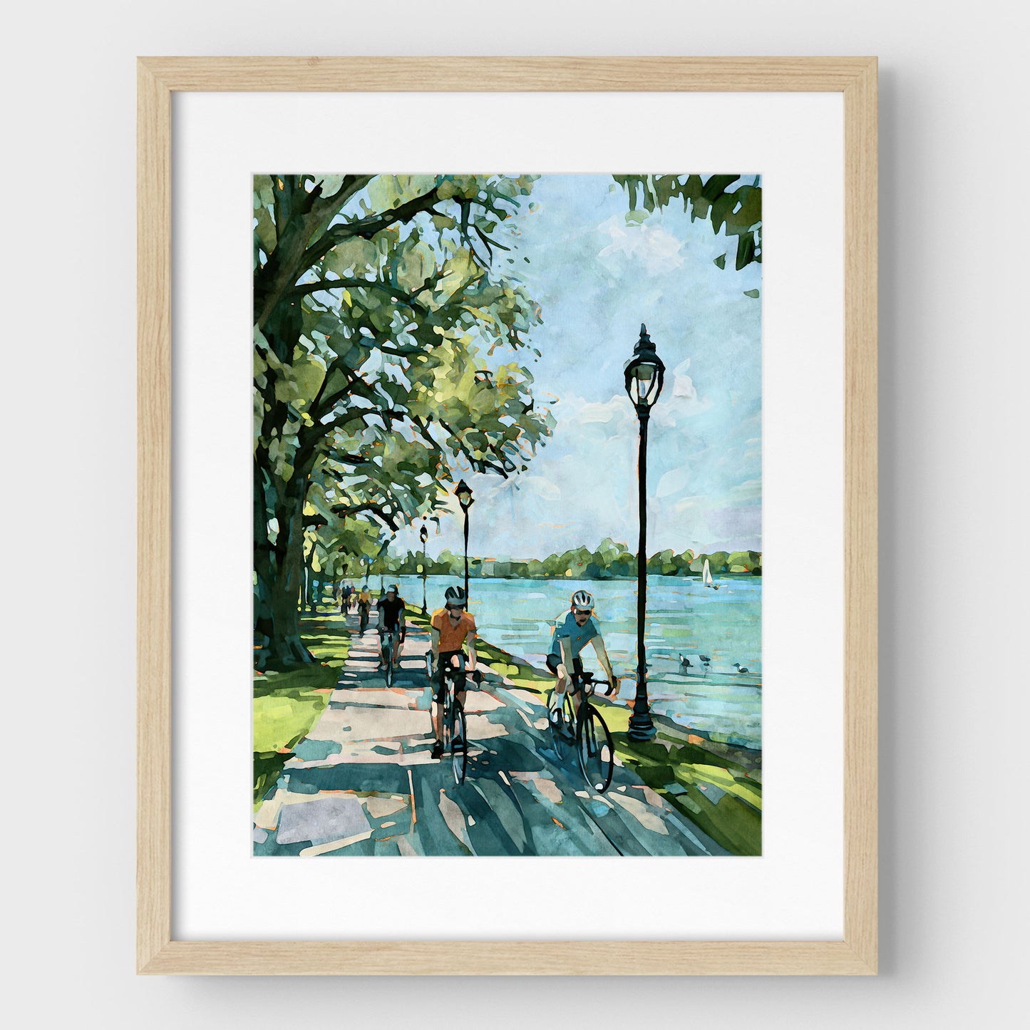 Matted Minneapolis Chain of Lakes cyclist art print in a natural wood frame.