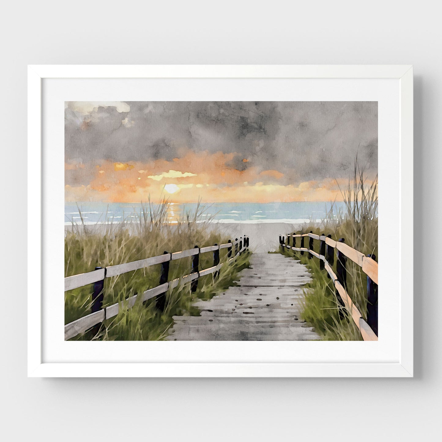 White framed artwork with a border, featuring a watercolor-style depiction of a wooden boardwalk flanked by grassy dunes, leading to the ocean at sunset with a dramatic cloudy sky.