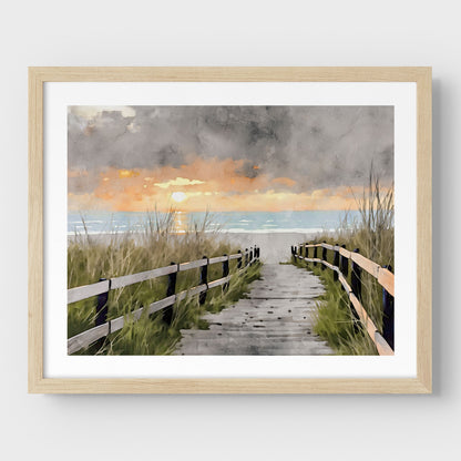 Natural wood framed artwork with a border, featuring a watercolor-style depiction of a wooden boardwalk flanked by grassy dunes, leading to the ocean at sunset with a dramatic cloudy sky.