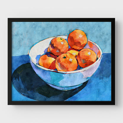 Bowl of oranges still life art print in a black frame with bold orange fruit, white bowl, and blue kitchen decor colors.