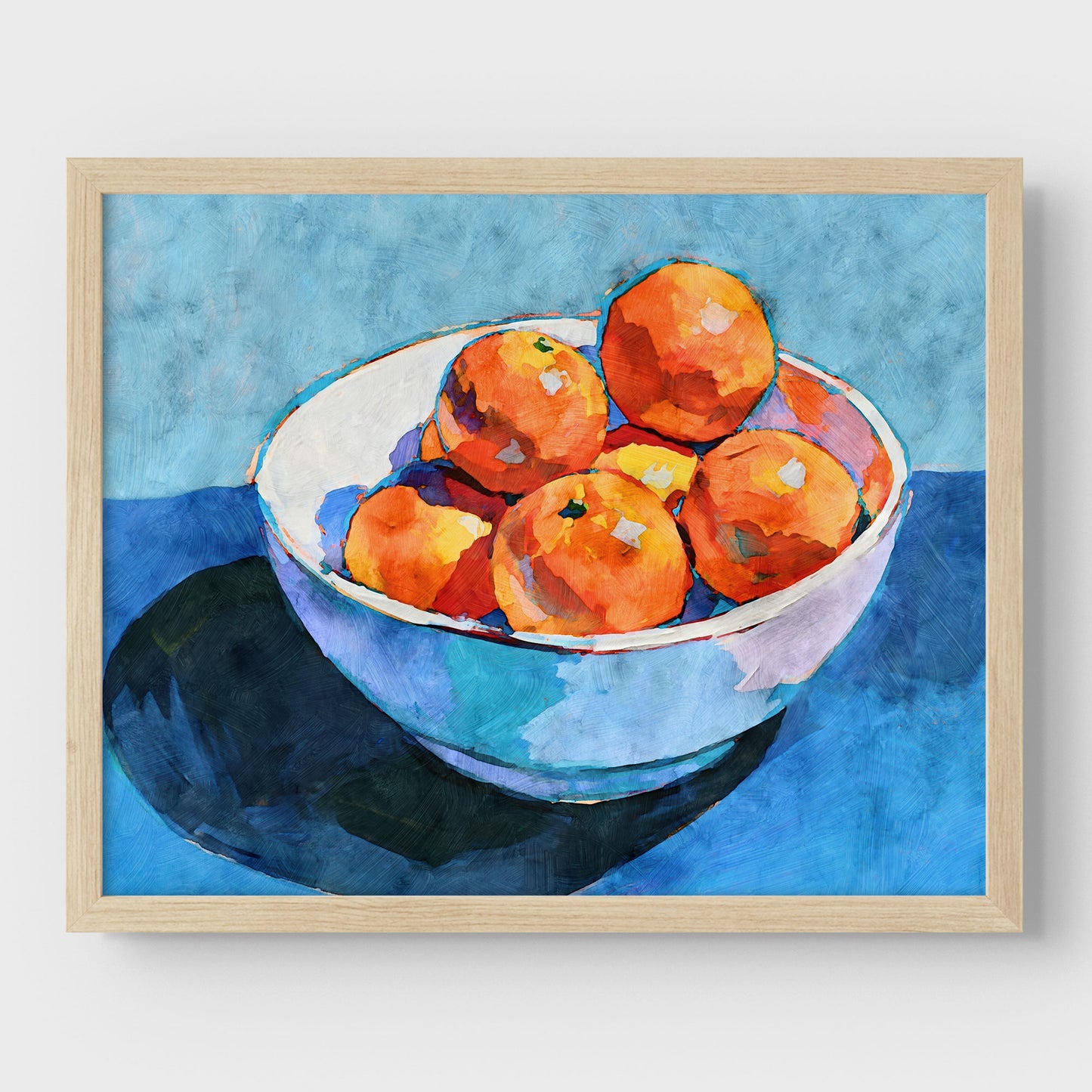 Bowl of oranges still life art print in a natural wood frame with bright orange fruit, white bowl, and blue background.