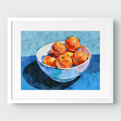 Bowl of oranges still life print in a white frame with mat, showing bright orange fruit and blue painterly shadows.