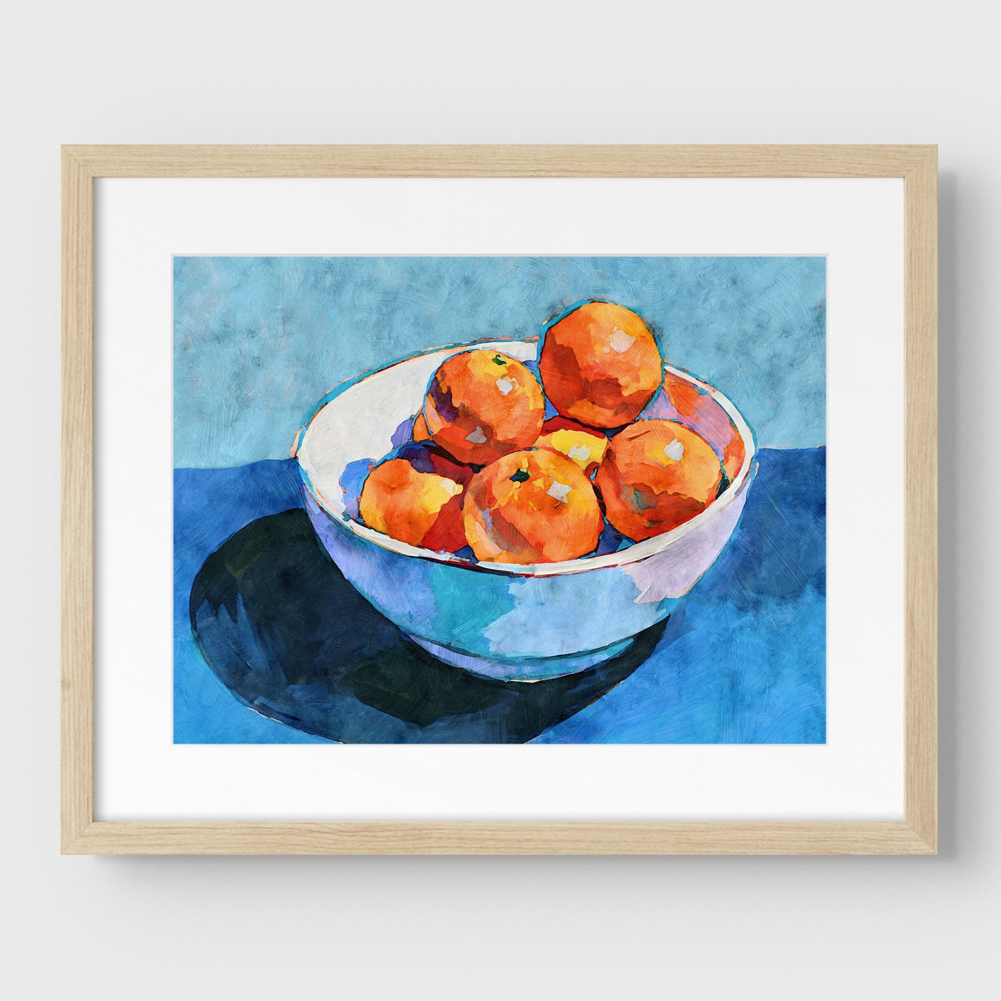 Bowl of oranges still life print in a natural wood frame with mat, with orange fruit, white bowl, and blue tones.