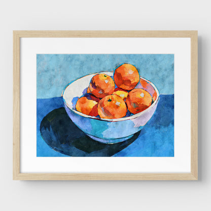 Bowl of oranges still life print in a natural wood frame with mat, with orange fruit, white bowl, and blue tones.