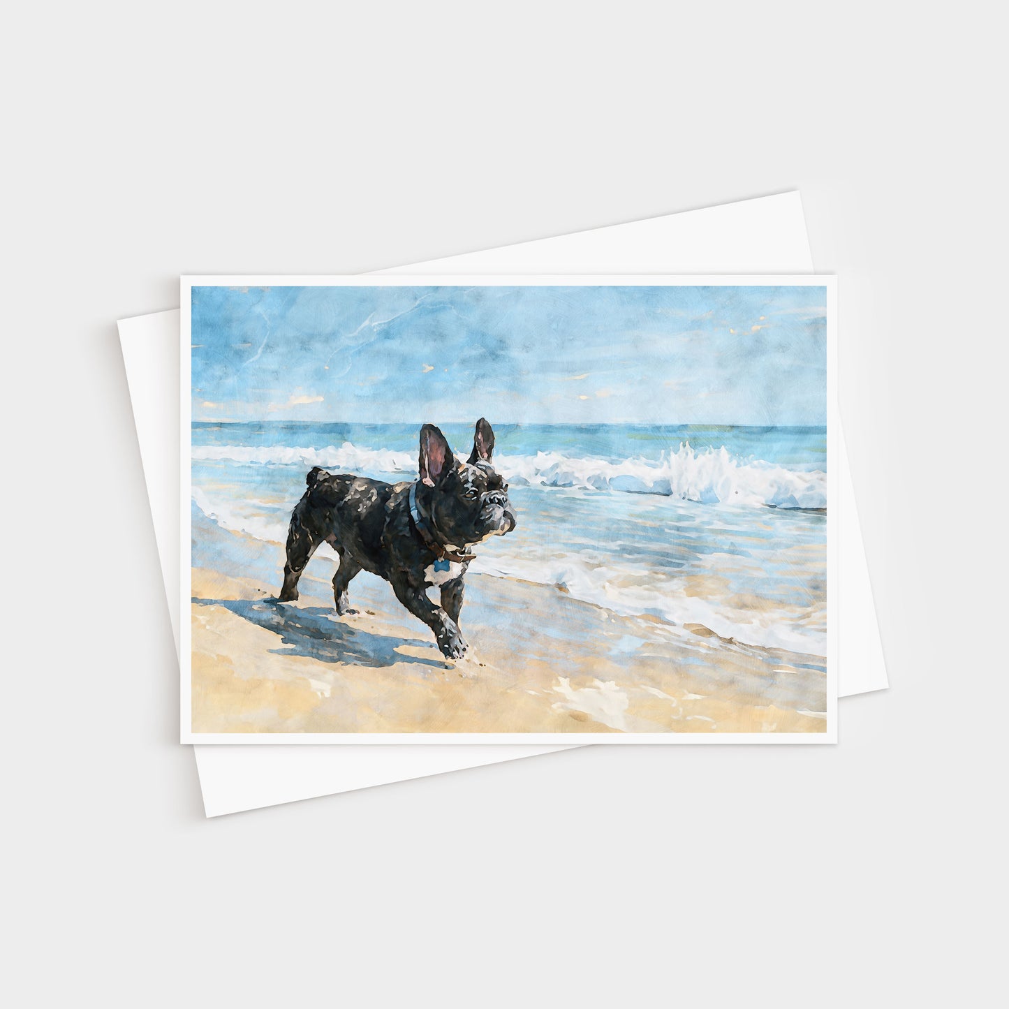 French Bulldog beach watercolor note card displayed with a white envelope and soft coastal blue tones.