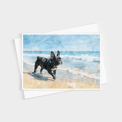 French Bulldog beach watercolor note card displayed with a white envelope and soft coastal blue tones.