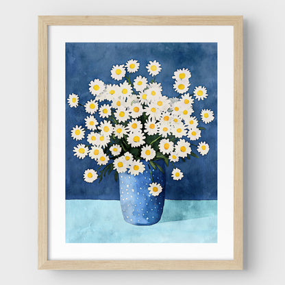 Artwork with a natural wood frame and white border, featuring a watercolor-style depiction of white chamomile flowers with yellow centers in a blue polka-dotted vase, set against a deep blue background and light blue surface.