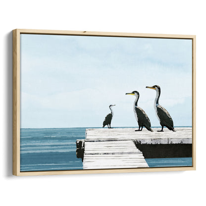 Natural wood framed canvas print featuring a minimalist seascape with three cormorants perched on a white dock above calm blue ocean water, under a pale sky.