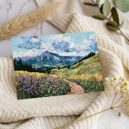 Painting of a mountain landscape with flowers and clouds on a textured surface.