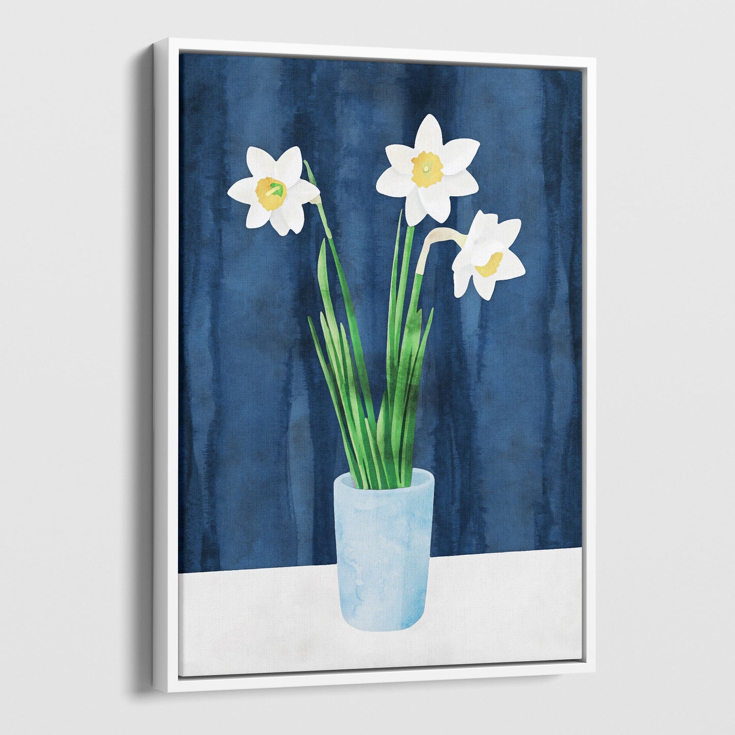 Framed canvas artwork with a white border, featuring a watercolor-style depiction of white daffodils with yellow centers in a light blue vase, set against a deep blue textured background.