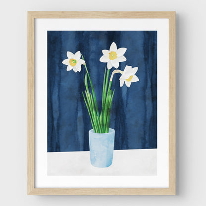Artwork with a natural wood frame and white border, featuring a watercolor-style depiction of three white daffodils with yellow centers in a light blue vase, set against a deep blue textured background.