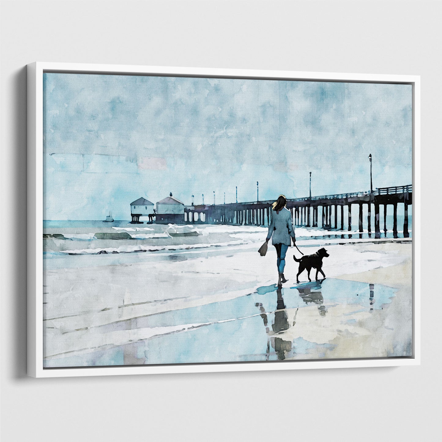 Watercolor-style illustration of a woman walking a dog along a wet beach with reflections, next to a long pier extending into the sea. Artwork printed on gallery wrap canvas in white floater frame.