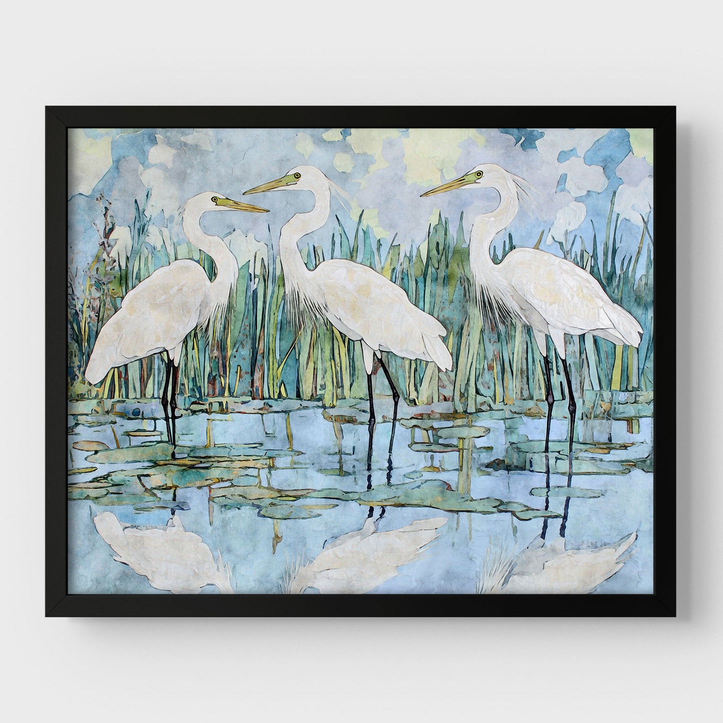 Framed artwork of three white herons in a marshy landscape.