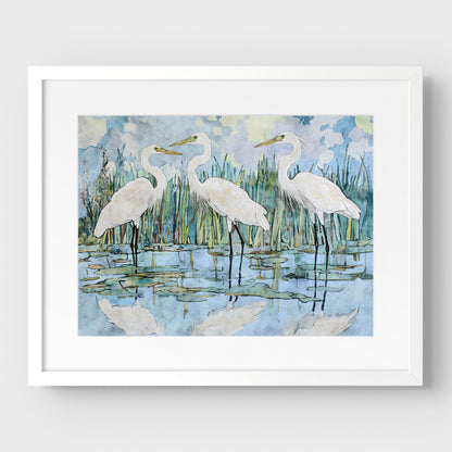 Framed artwork of three white egrets in a marshy landscape.